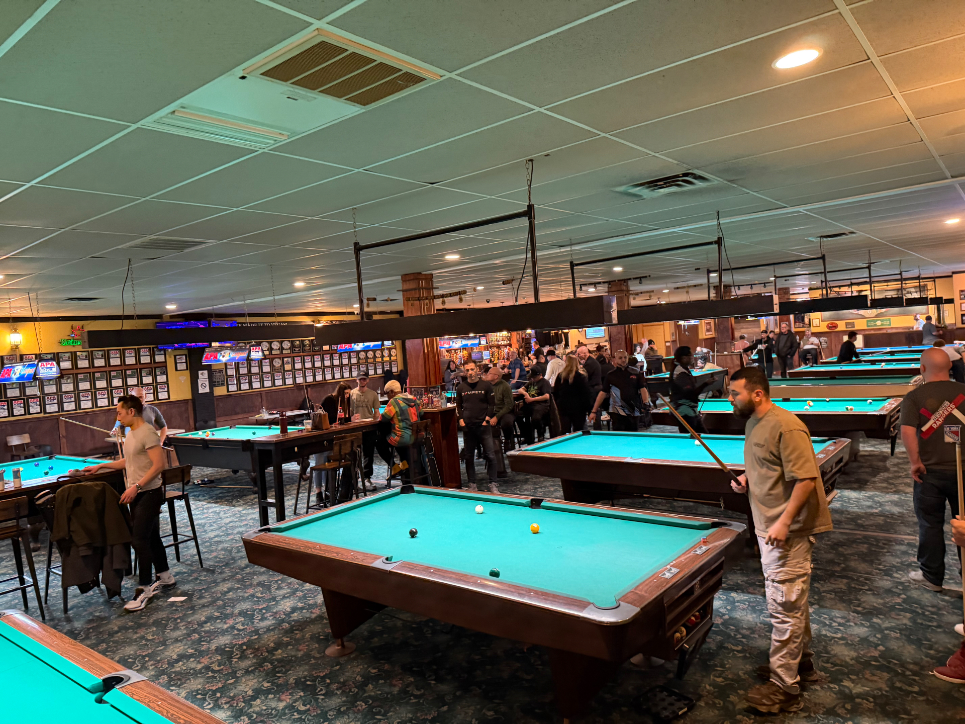 Queens Pro Pool League players gathering at the pool hall